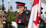 2014 Memorial Service - Officers standing next to a flag