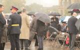 2012 Memorial Service - guests at memorial service in the rain with umbrellas