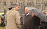 2012 Memorial Service - guests at memorial service in the rain with umbrellas (2)